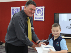 Benjamin Pumfrey receives his award from Director of System Performance (Greater Blacktown) Paul Menday